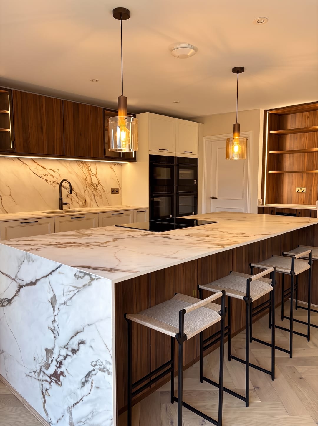 Kitchen island with pendant lights and bar stools