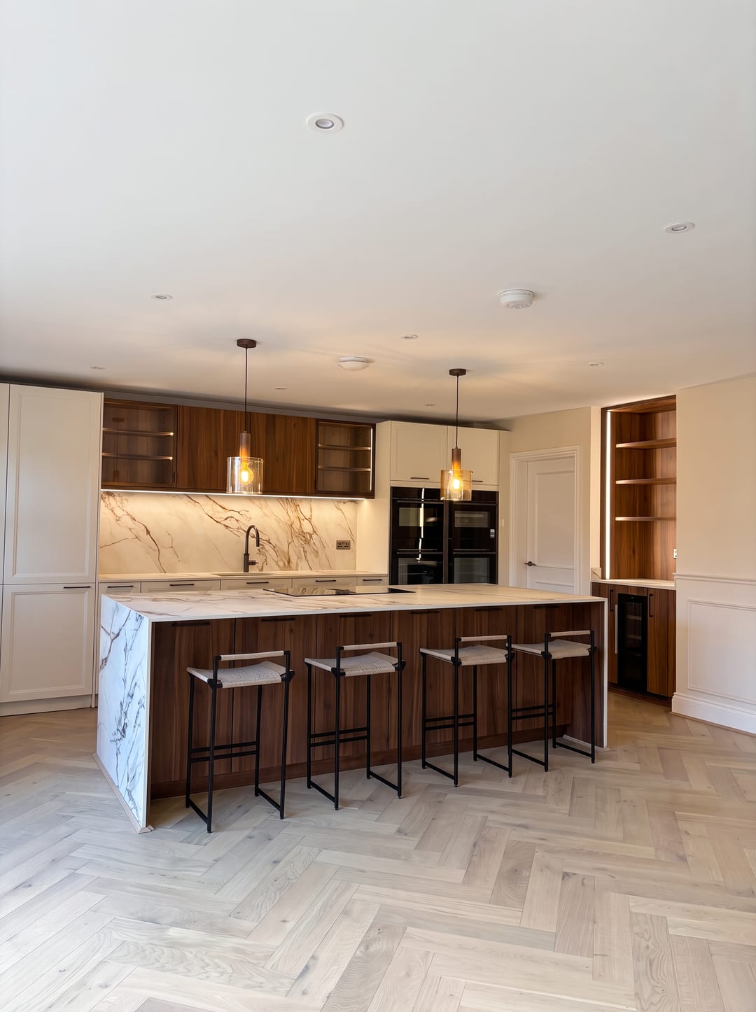 Kitchen with a marble-effect porcelain island and dark oak cabinetry