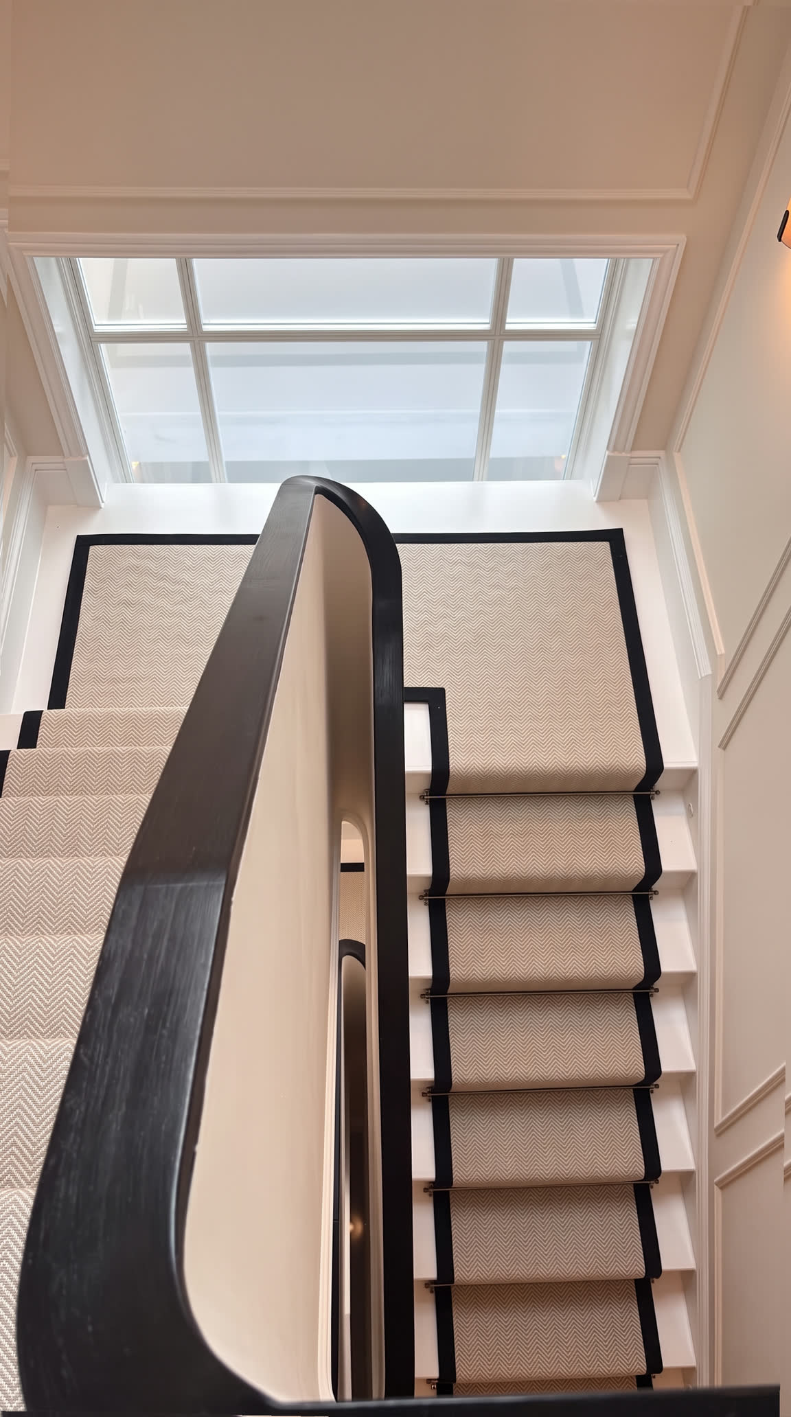 The stair from above, beneath a roof light