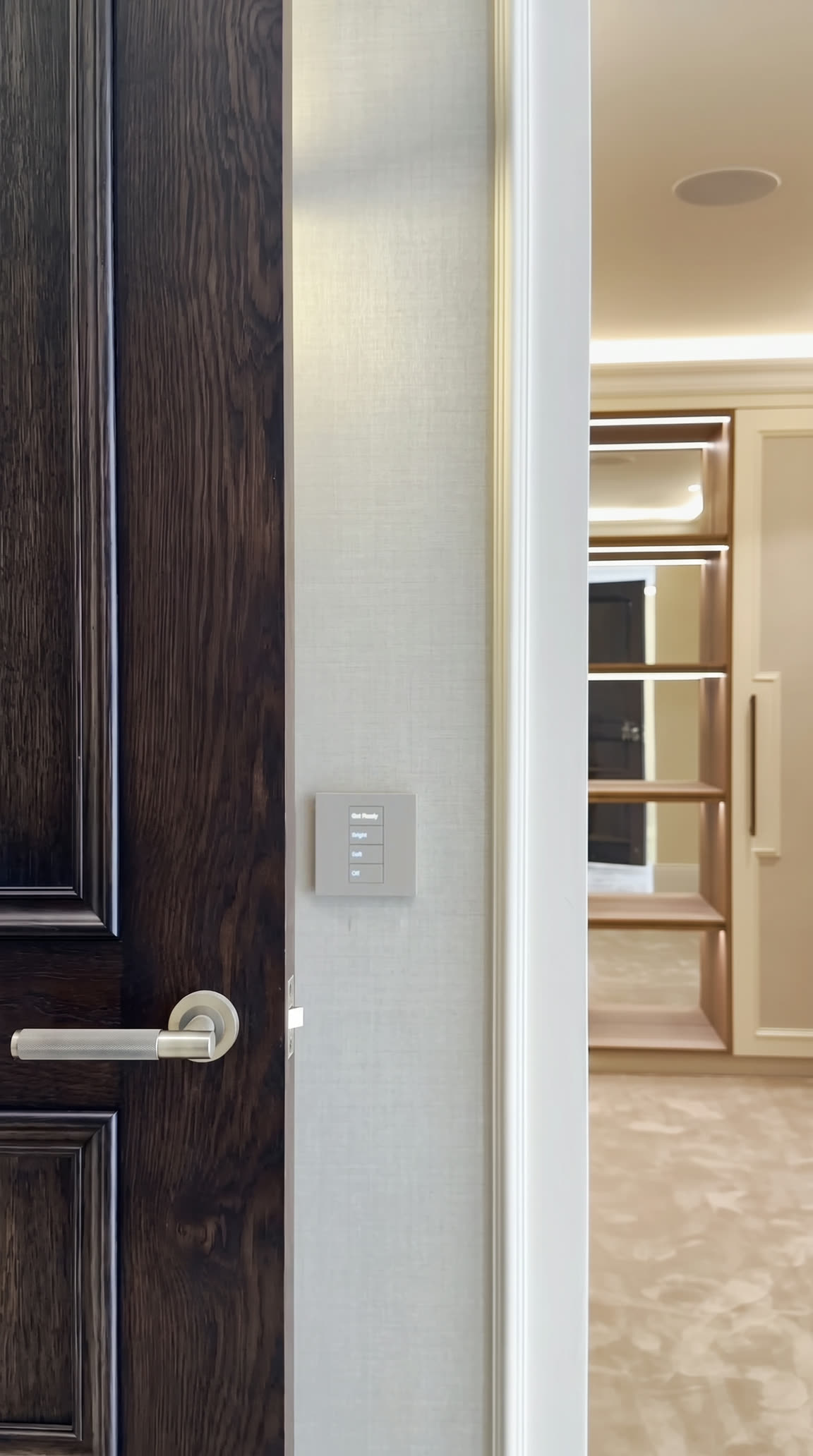 Dark oak door opening into the dressing room