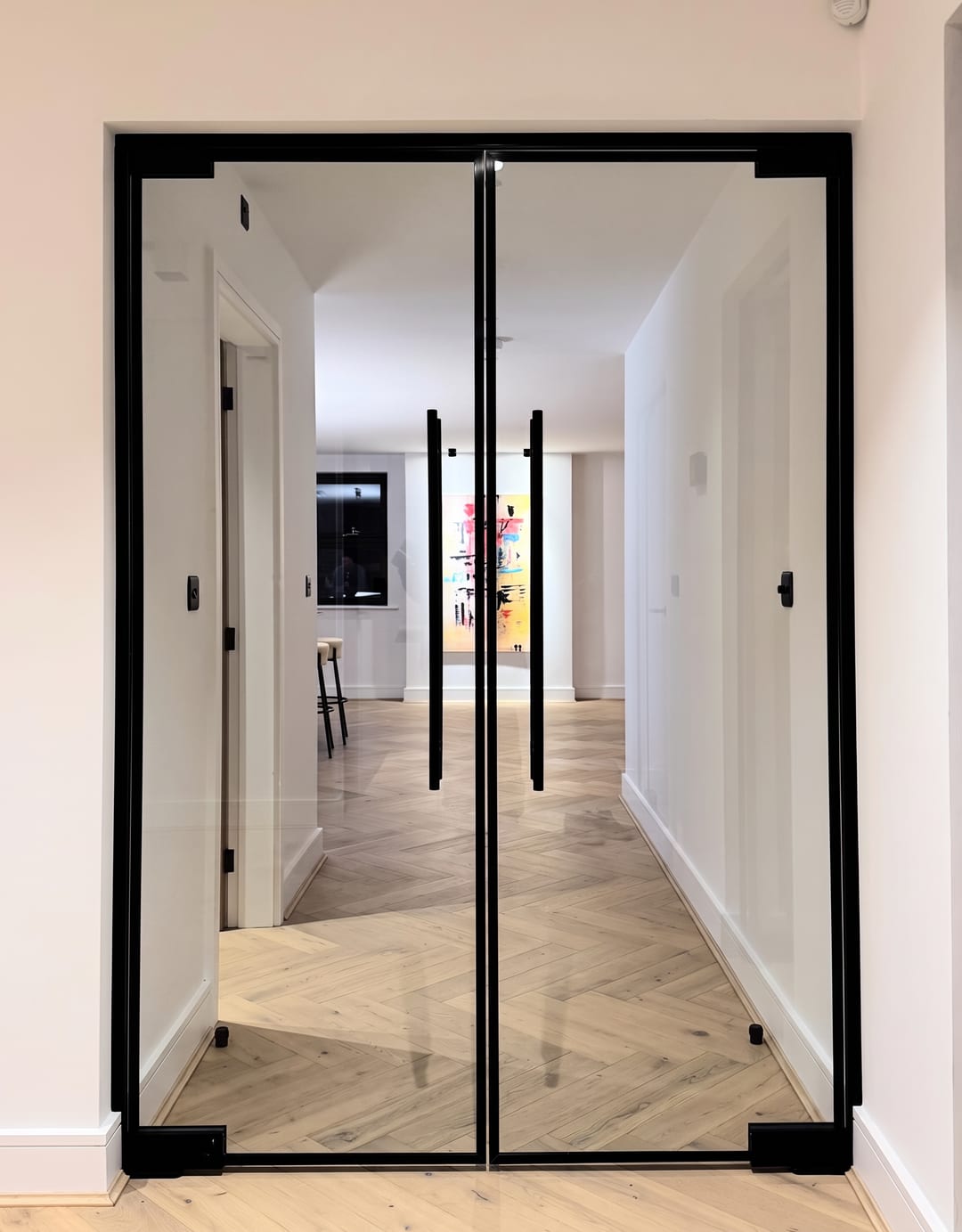 Oak View: black steel-framed glazed double doors opening onto herringbone oak